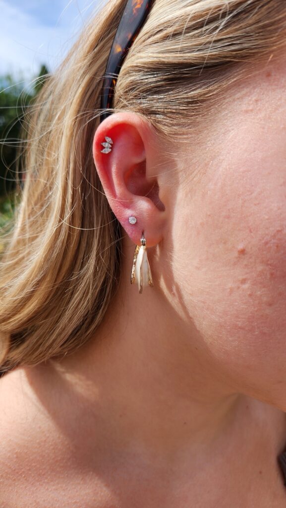 Flat with lobe hoop piercing by Gabi at Hypnotic Art Tattoo Studio, Milton Keynes