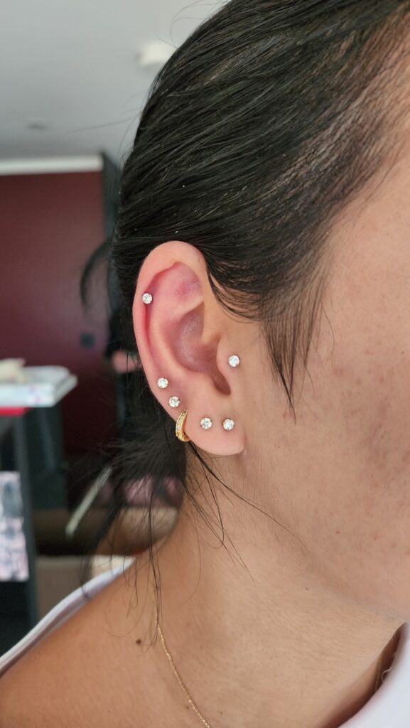 Helix, flat and stacked lobes piercing by Gabi at Hypnotic Art Tattoo Studio, Milton Keynes