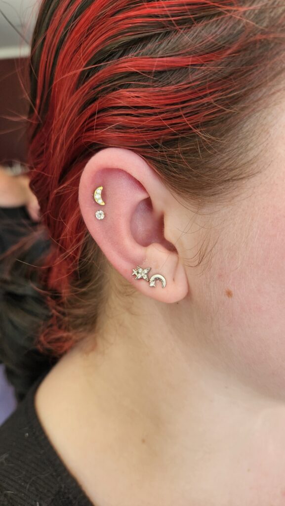 Helix pair with curated lobes piercing by Gabi at Hypnotic Art Tattoo Studio, Milton Keynes