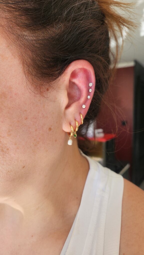 Triple helix with lobe hoops piercing by Gabi at Hypnotic Art Tattoo Studio, Milton Keynes